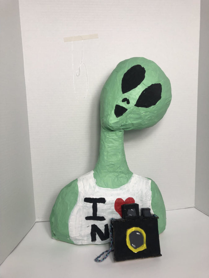Senior+Maggie+Johnsons+sculpture+of+an+alien+tourist+made+with+paper+mache.%0A