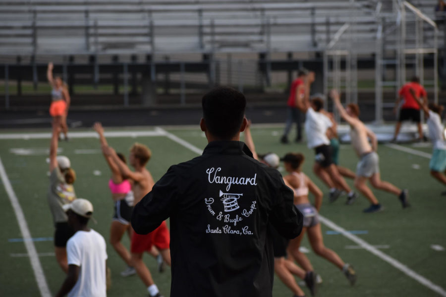 The right-field drum major conducts during a rehersal run of Santa Clara Vangaurds 2022 show Finding Nirvanna. They have 4 total drum majors that conduct from different places on the sideline. 