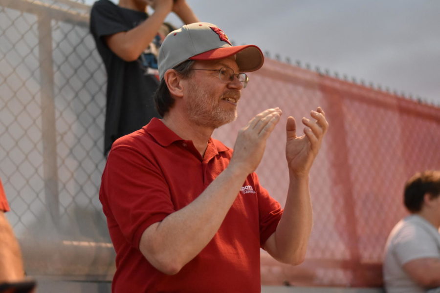 Steve Bean applauds the Marching Cards at the Columbus North v. SHS football game on Sept. 2. SHS lost 14-47.