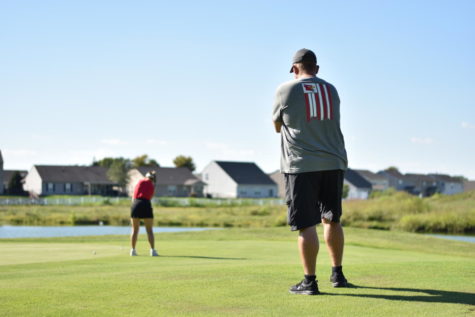 Jody Matthews watches his daughter, Hannah Matthews, golf on Aug. 31 at Southern Dunes Golf Course. Matthews shot a 44 and was the medalist for the match.