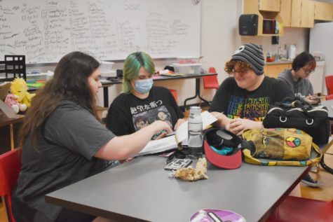 Trinity Wagner, Jay Brumley and Zack Tackett gather around a table to work on content for SHSs new literary magazine on Sept. 14. The magazine staff met during iPass. 
