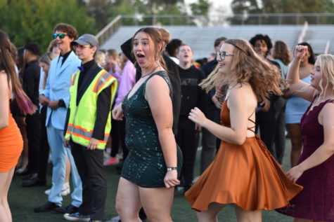 Seniors Kaitlin Osborne and Rachel Borho dance to Cotton-Eyed Joe at the homecoming dance on Saturday. The two continued to dance in the crowd for several songs. 