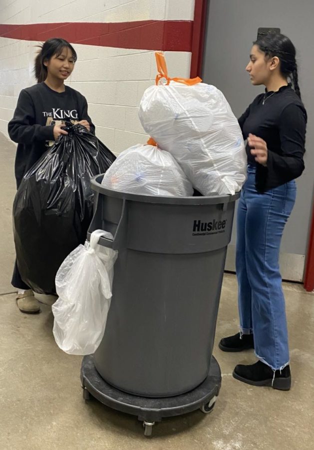 Juniors Rem Tial and Manprit Kaur complete their club duties on Jan. 27. The club meets up every Friday to pick up trash for recycling.