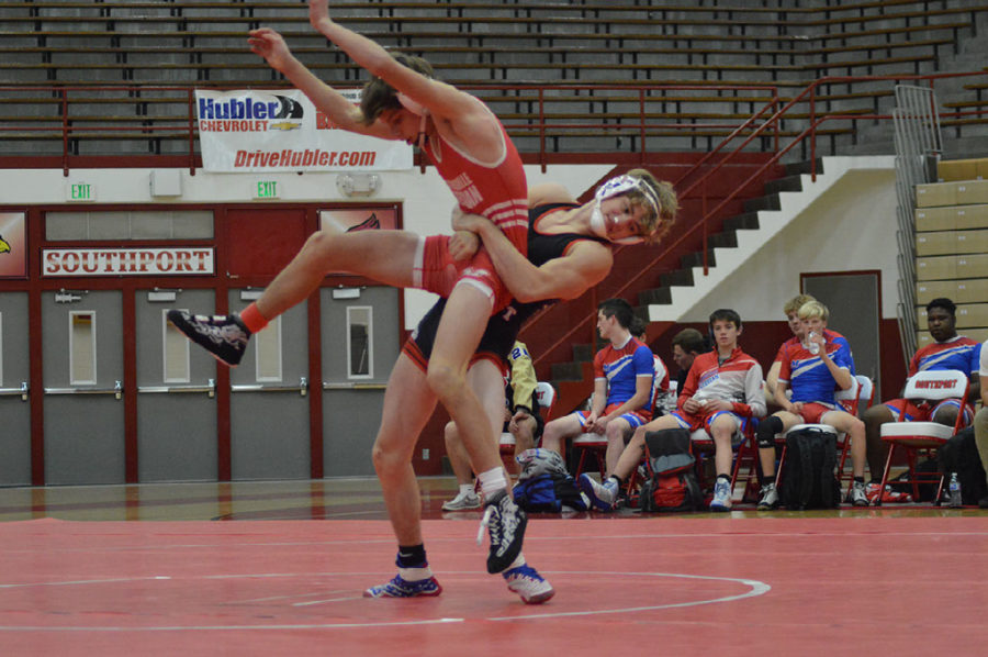 Josh Foxworthy (24) throws his opponent to the ground. Foxworthy is excited for The Cards wrestlers to gain experience during the tournament.