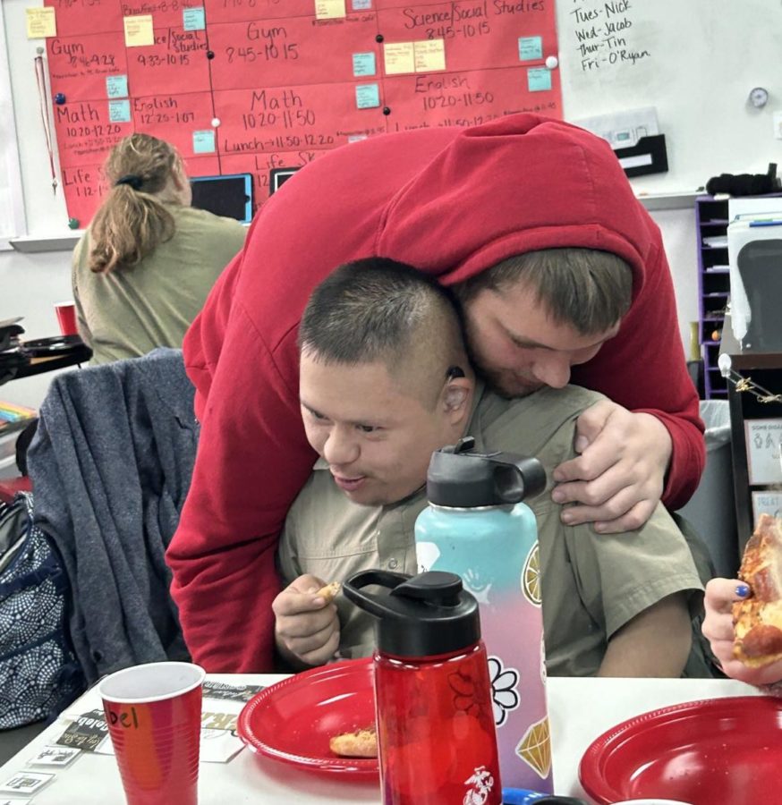 Senior Austin Brown gives Senior Abel Tajonar an embrace at the Thanksgiving party on Nov. 17. This was hosted by Best Buddies. 