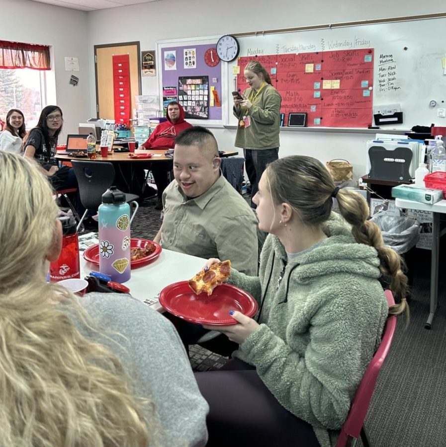 Senior Abel Tajonar sings Jingle Bells for the class during the pizza party on Nov. 17. This was also known as the Thanksgiving party that Best Buddies hosted. 