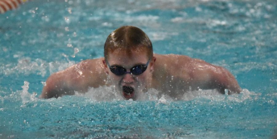 Sophomore+Charlie+Kottlowski+swims+the+100+yard+butterfly+on+Dec.+13.+Both+the+boys+and+girls+swim+teams+went+on+to+win+against+the+Whiteland+Warriors.