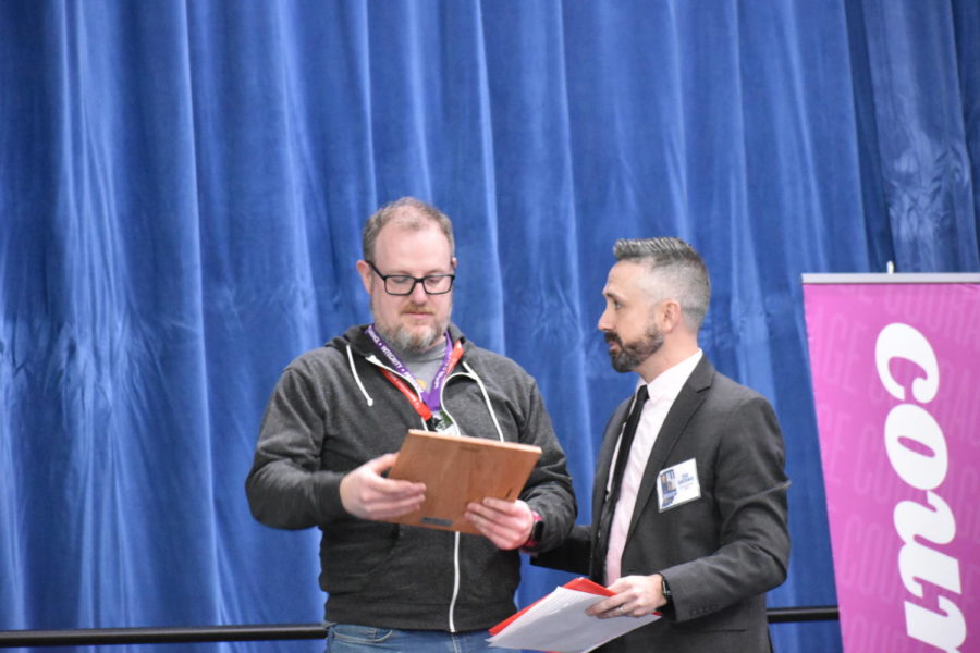 Anchor adviser Sam Hanley receives a plaque with his name and award on it. Executive director of the IHSPA Ryan Gunterman handed him his plaque and congratulated him on the stage. 