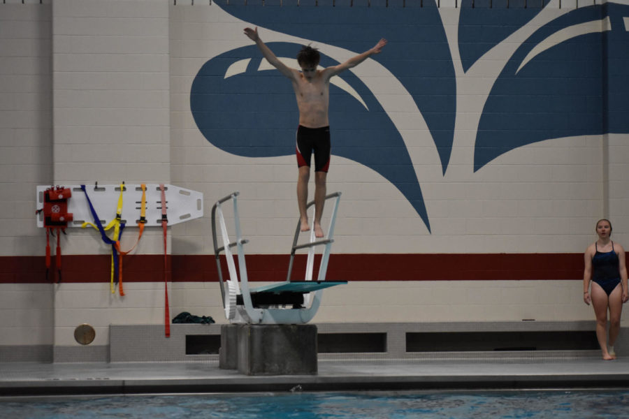 Then freshmen Hayden Black jumps on the diving board to gain power before completing his dive on Nov. 22, 2021. Black improved on his results from last season by qualifying for the regional meet this year.