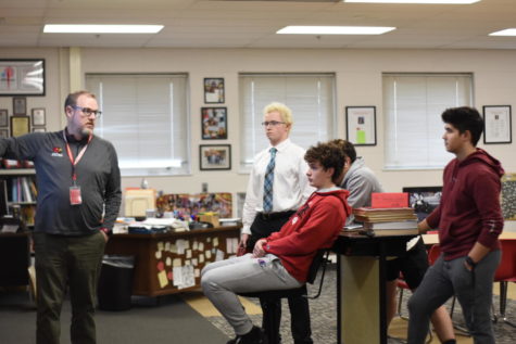 Booster Club Adviser Sam Hanley talks to officers Drew Youmans, Johnny Romo and Charlie Kottlowski. The Booster Club holds meetings every Tuesday after school. 