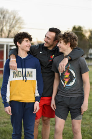 Kevin (left) and Tristan Keefe (right) smile at their uncle, Brendan Dudas, at the SHS baseball field on March 8. Dudas took the boys in after the family decided their mother couldnt care for them anymore.