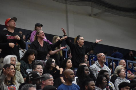 SHS fans raise their arms in frustration at the referees during the first round of basketball sectionals at Perry Meridian on March 1. Many fans of the Cards thought that the officials were biased towards the opposing Ben Davis Giants.