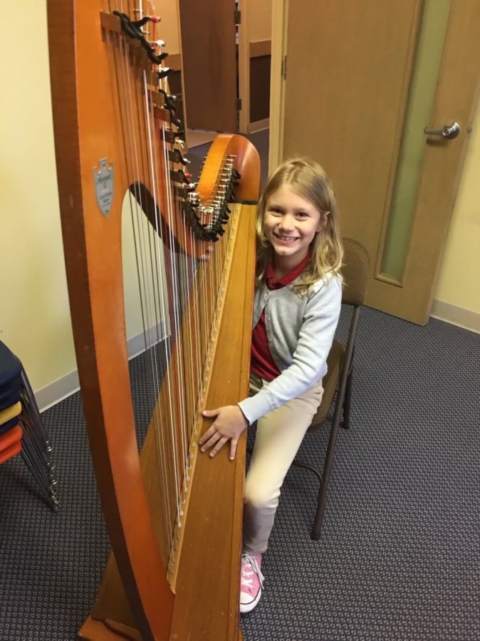 Freshman Halle Kenyon receives her first harp after only having a baby harp before. This was a step up for Kenyon as she grew along with her passion for the instrument. photo contributed by freshman Halle Kenyon 