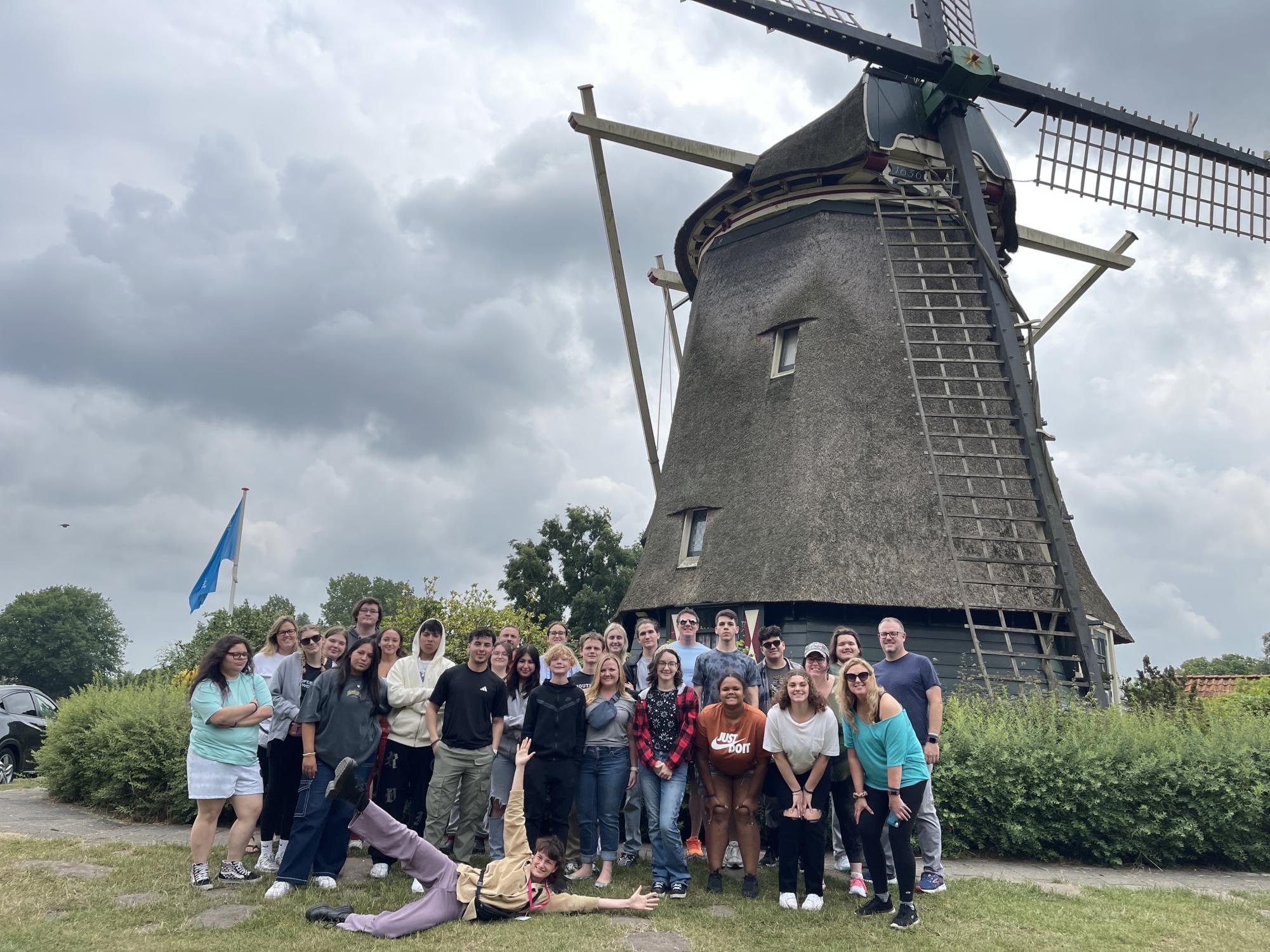 SHS Travel Club in front of a traditional Dutch windmill in Amsterdam.
