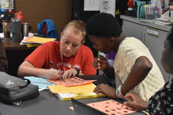 Biology teacher, Daryl Traylor, helps El student with an assignment. 