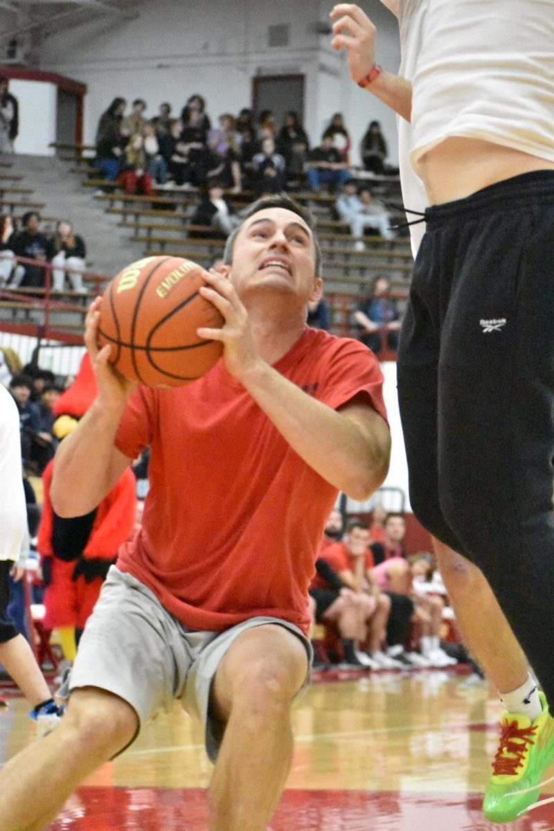 Math teacher Bradley Mitchell gets blocked in an attempt to shoot the ball.