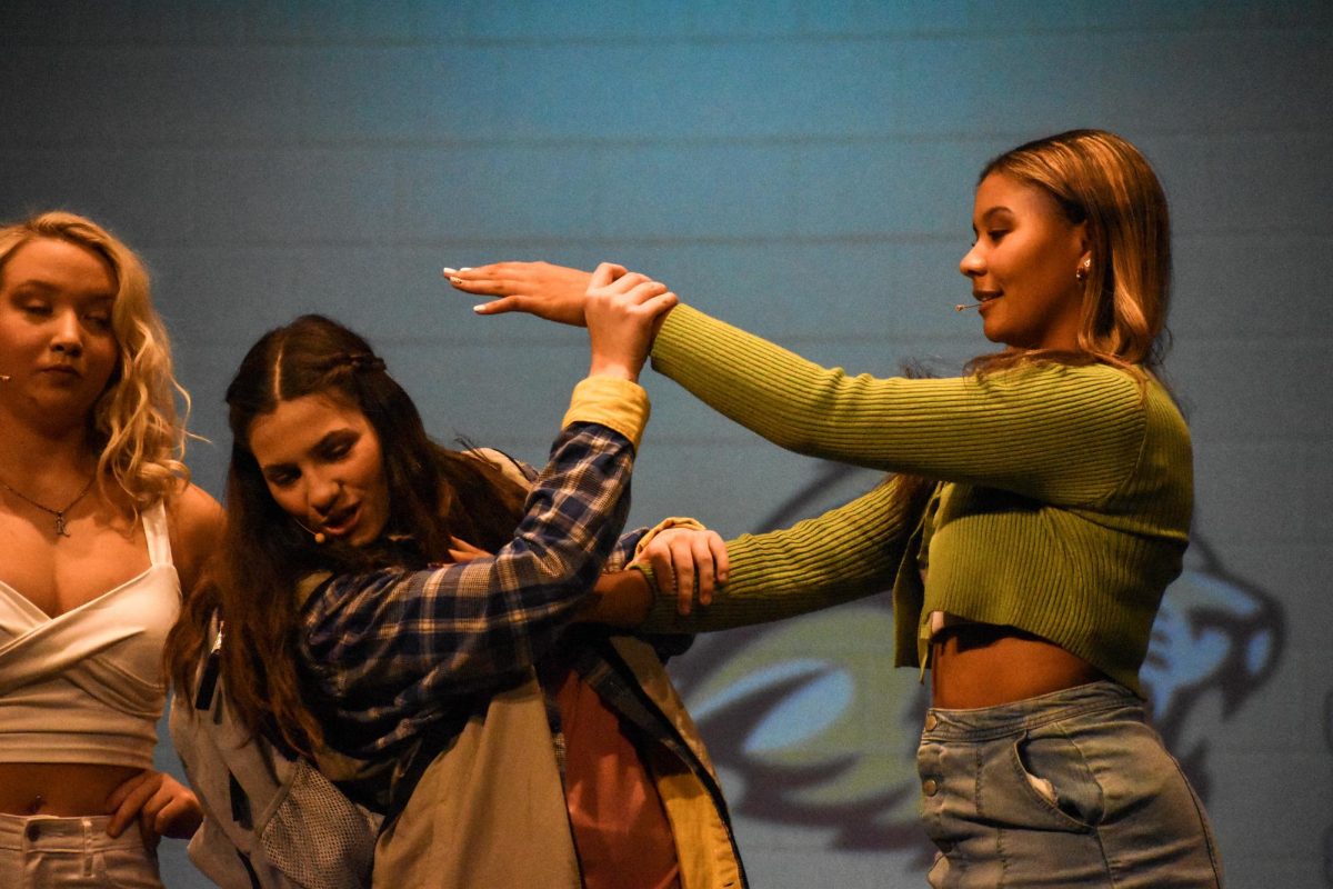 Junior Keyona Graham (Karen) reaches out to touch senior Annabelle Southerns (Cady) hair.