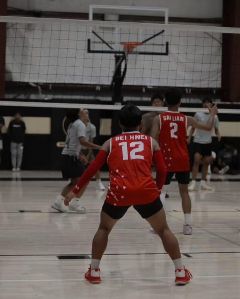 Senior Bei Hnei and his club team stay focused during their volleyball game.
