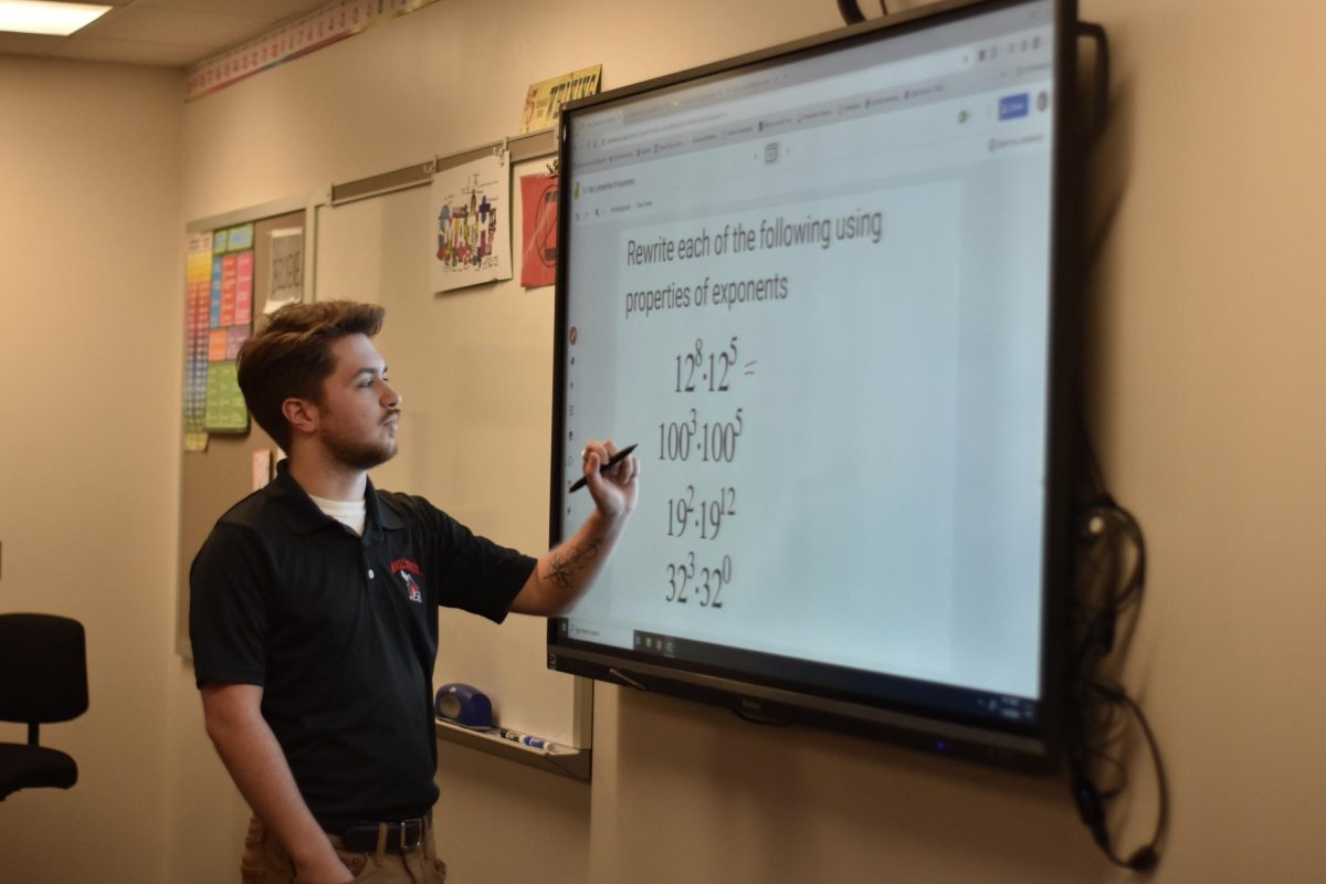 Alexander Mitchell explains math problem to an Algebra 1 class. Mitchell graduated from SHS in 2020 and has returned to student teach. 
photo by Darcy Leber