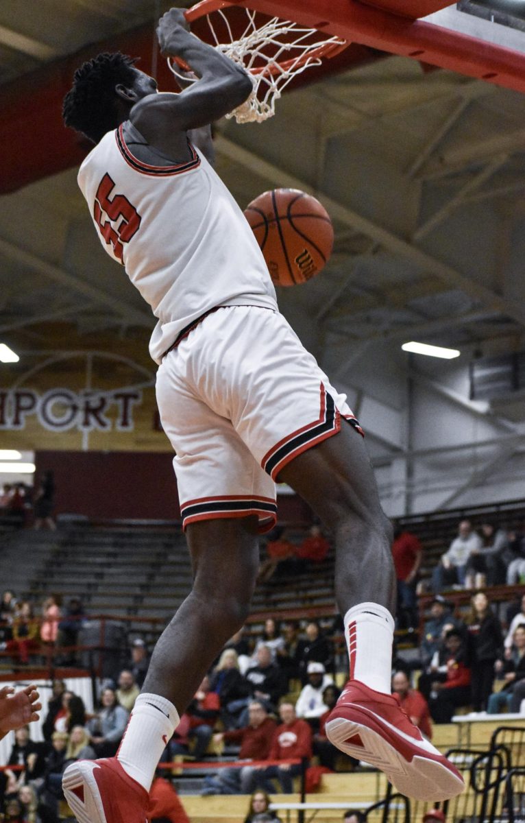 Sophomore James Kalala dunks the ball during the game on Thursday, Feb. 1 in the Fieldhouse. The team won the game 72-65.