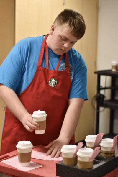 Sophomore Michael Thomas matches cups to order forms from teachers. 