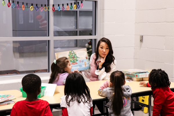 Director of Communications Elizabeth Choi reads to a holiday themed book to students. Choi has been working on expanding  the communications department for Perry Township. 
photo contributed by Elizabeth Choi