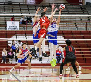 Senior Britain Givens hits the ball over the net during the boys volleyball doubleheader on Friday, April 5 in the Fieldhouse. (photo contributed by James Perez)