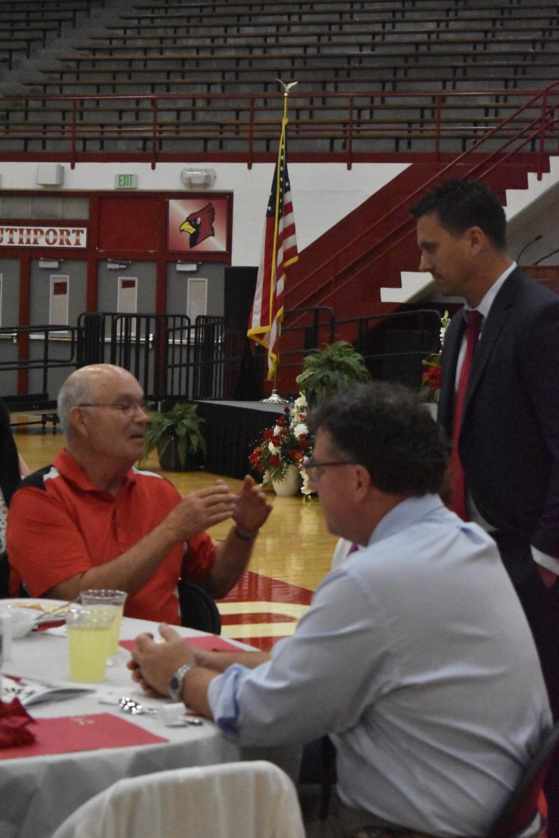 English teacher Brent Bockleman (top right) talks with SHS alum at the Alumni Dinner on Monday, May 20. Seniors are able to apply for scholarships and then 