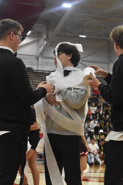 Senior Fabian Tapscott is wrapped with toilet by juniors Myles Caudill and Gavin Cummins. They won the game. photo by Salem Ortega-Morales