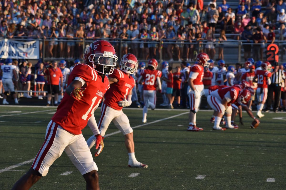 Senior Nilyn Compton checks with the sideline official to see if he is set. This was his last time ever playing Roncalli for football in his career.