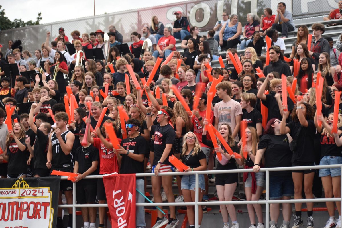 The student section cheers after a play during the 24-25 homecoming football game against Columbus North. The Cards lost 45-14. (Photo by Kennedy Cochran)