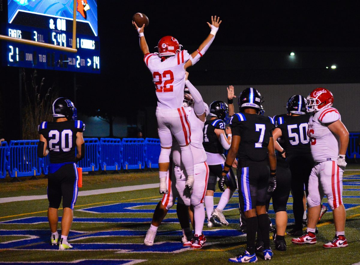 Senior Cooper Gannon lifts up junior Riley Matlock to celebrate a rushing touchdown. The cards lost 44-34. (photo by Aiden Quinlin)