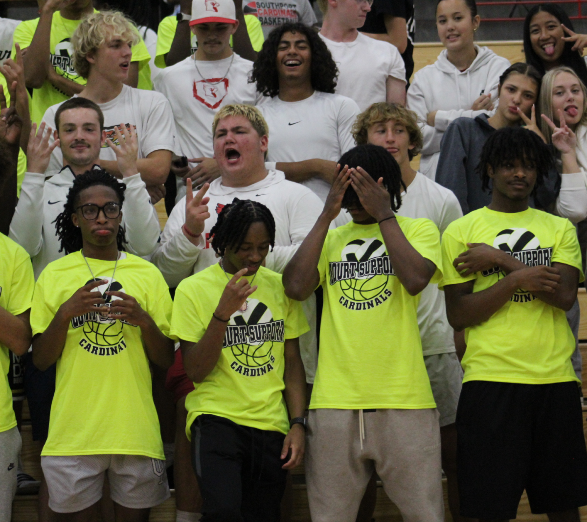 Basketball players and students pose for a photo in the student section during the girls volleyball game against THS. The lady cards won 3-1. (photo contributed by Southport Athletics)