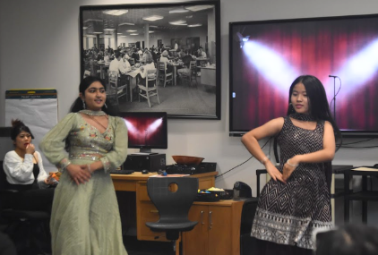 Students Cing Kim and Diya Patel perform a traditional Indian dance during the Mini Culture Fair on Friday, Oct. 4. Patel performed in the cultural showcase last year.