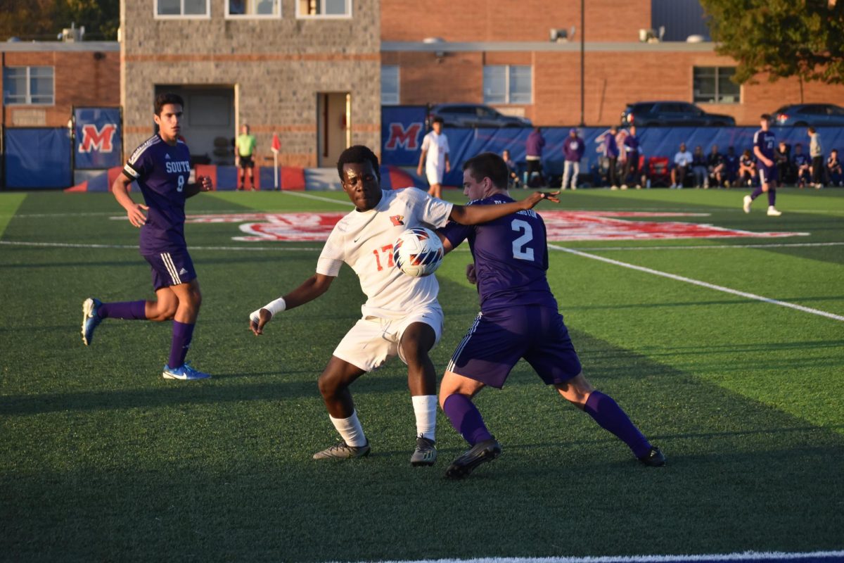 Senior Dieu Ebuela tries to win possession of ball. The team lost 5-2.photos by Caydence Davis