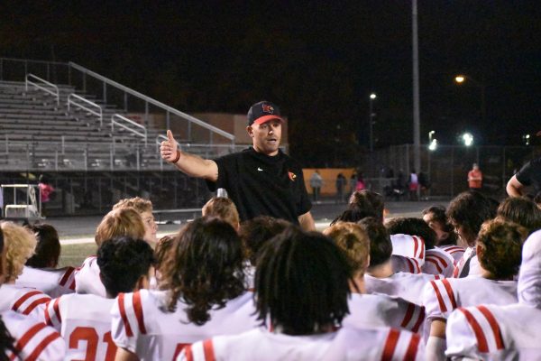 Former football head coach Alex Bettag talks to his team after his second career win against the Arsenal Tech. On Monday Nov. 18, Bettag was let go from the position after 4 years of coaching. photo by Morgan Harmon.