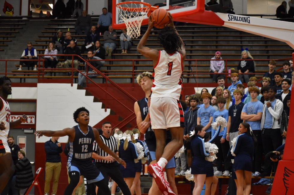 Senior Ty’Reese Burnett goes up for a lay up against a defender. Boys basketball won their season opener against rival Perry Meridian. (photo contributed by Joclynn Wiles.)