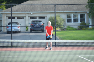 Senior Charles Kottlowski prepares himself to serve the ball. Kottlowksi is a recognized leader on the team by his teammates and coaches. (photo contributed by Ava Stacy)