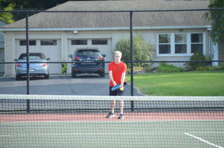 Senior Charles Kottlowski prepares himself to serve the ball. Kottlowksi is a recognized leader on the team by his teammates and coaches. (photo contributed by Ava Stacy)