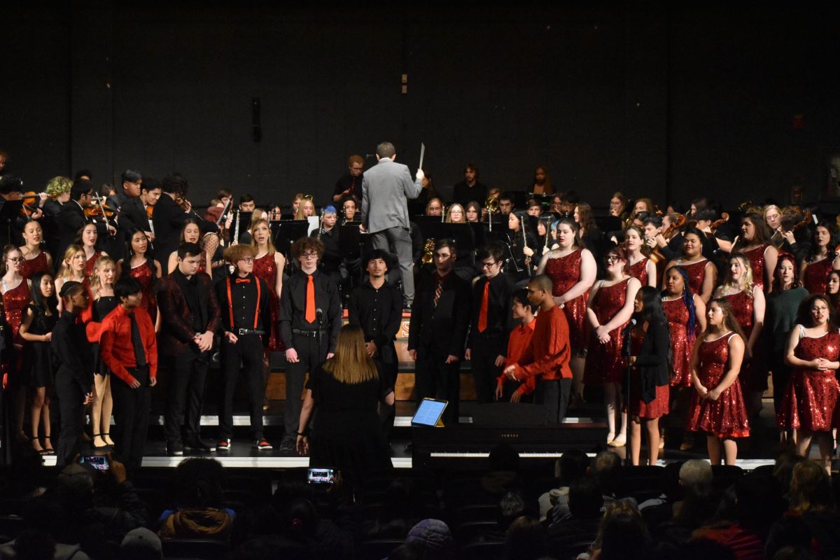 Band director Jeff Maupin conducts the program. All the advanced music groups performed together. photo by Kiley Bowman