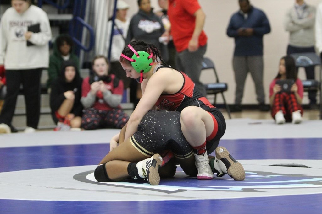 Senior Kyla Johnson works to pin down an opponent. Johnson is going into her seventh year of wrestling and is now ranked number one in the state for the 125 pound weight class. photo contributed by Kyla Johnson