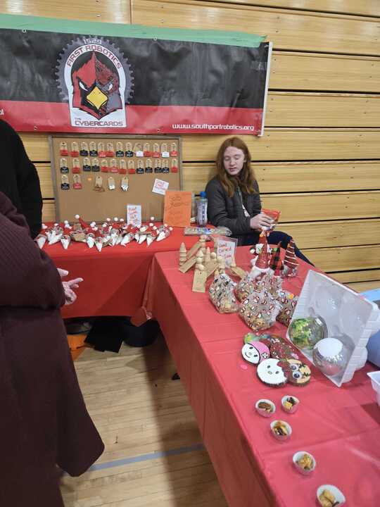 Members of the robotics team attend the craft fair on Nov. 16. They have a booth set up with items they've crafted.
Photo contributed by Chloe Cripe