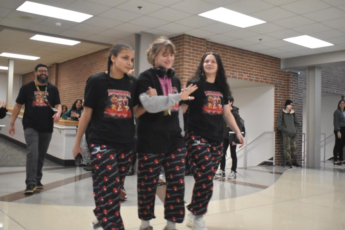 The three girl wrestlers, freshman Hope Senteney, senior AvaLyn Mosconi and senior Kyla Johnson, who have advanced to state are recognized in their own parade around the school hallways. The three wrestle tomorrow, Jan. 17.