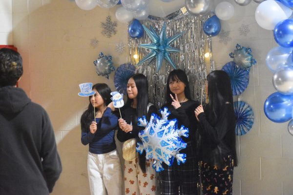 Freshmen Christina So, Par Mawi and Ritter Kim pose for a photo. There was a polaroid photo booth at the event. photo by Caydence Davis 