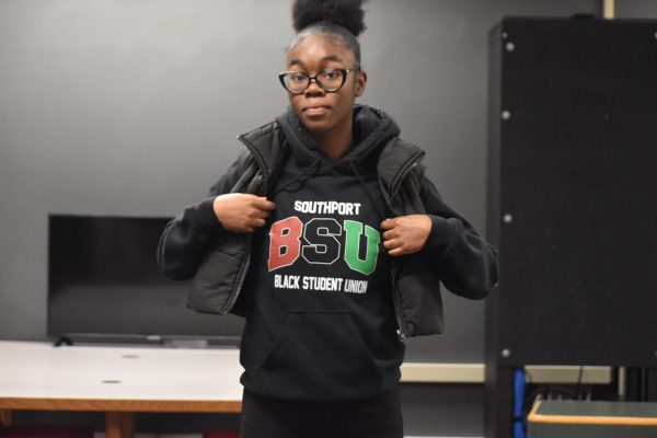 President of BSU and senior Rihanna Fields showcases the club's merch during the Black History month celebration on Feb. 14. 