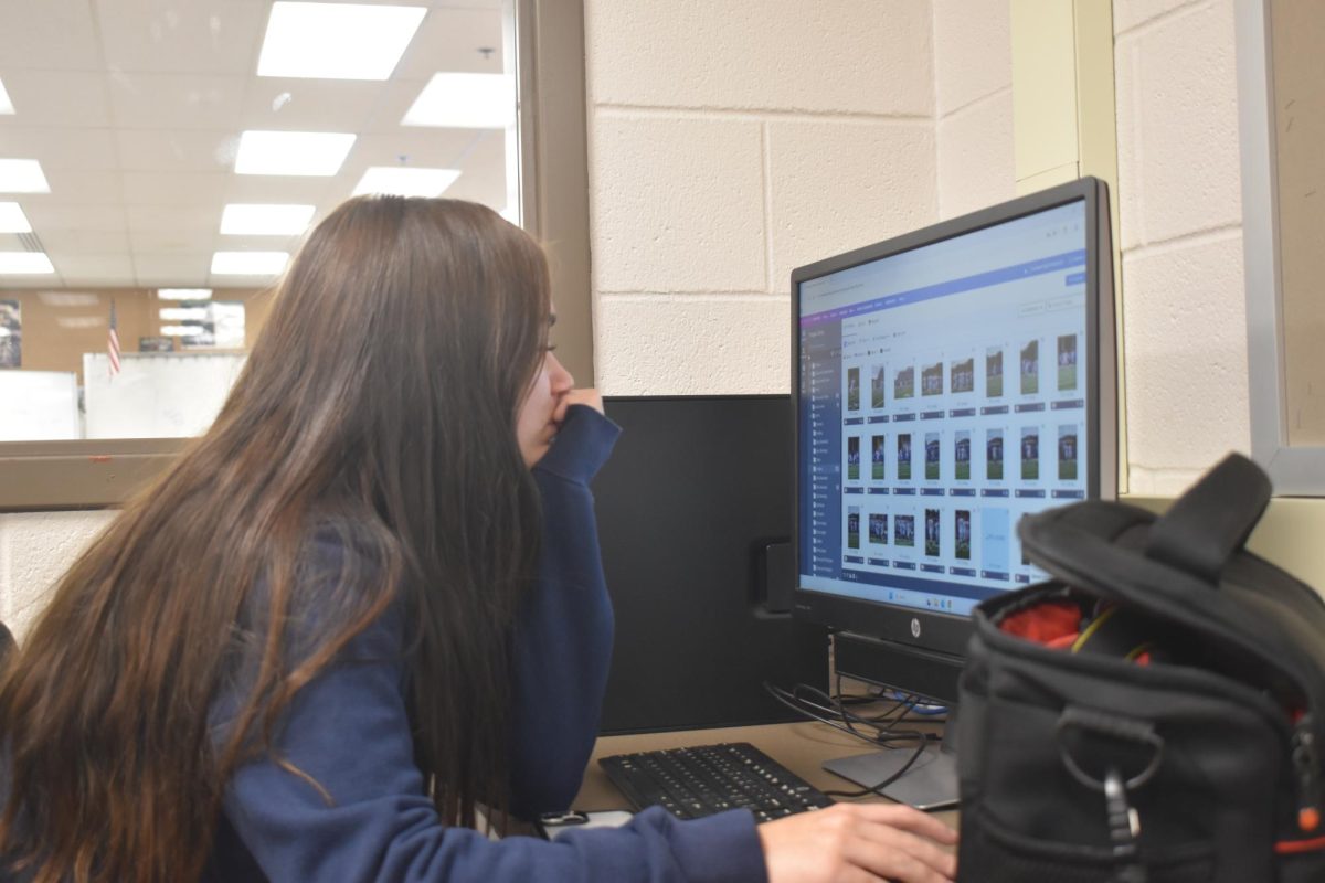 Junior Jocylnn Wiles sits at her computer and works during The Anchor's class period on Monday, Aug. 25. Wiles fills the position as album editor this year on the staff.