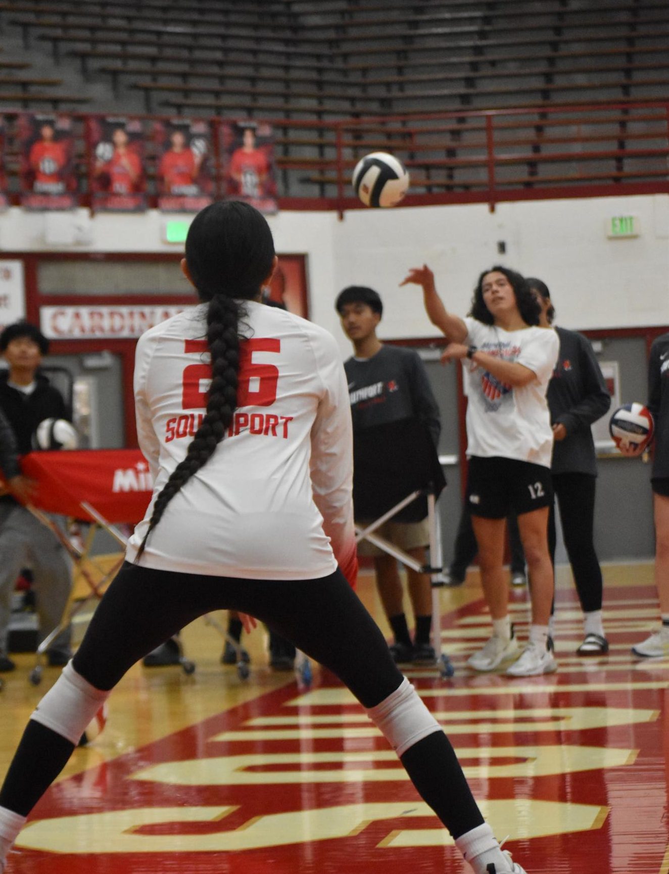 Senior Rey Martinez serves to freshman sister Angie Martinez during warm ups of the junior varsity SHS girls' volleyball game. On Tuesday, Aug. 19 the junior varsity Lady Cards would win against Pike 2-1. 