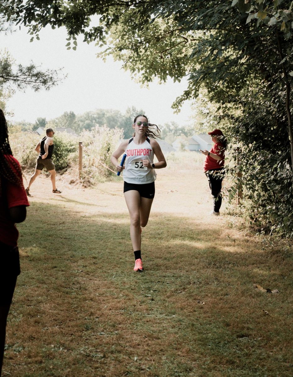 Senior Erin Herwehe runs during the first cross country meet of the season on Saturday, Aug. 16. at Pike high school. The team would place third at the meet. (photo contributed by Erin Herwehe)