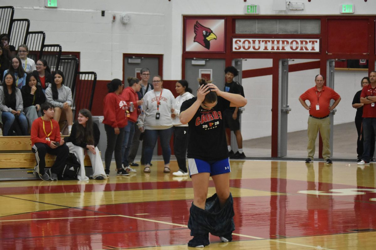 Junior Lorelei Bennett's pants fall as she walks into the gym representing Booster Club. Bennett threw her pants into the crowd moments later.