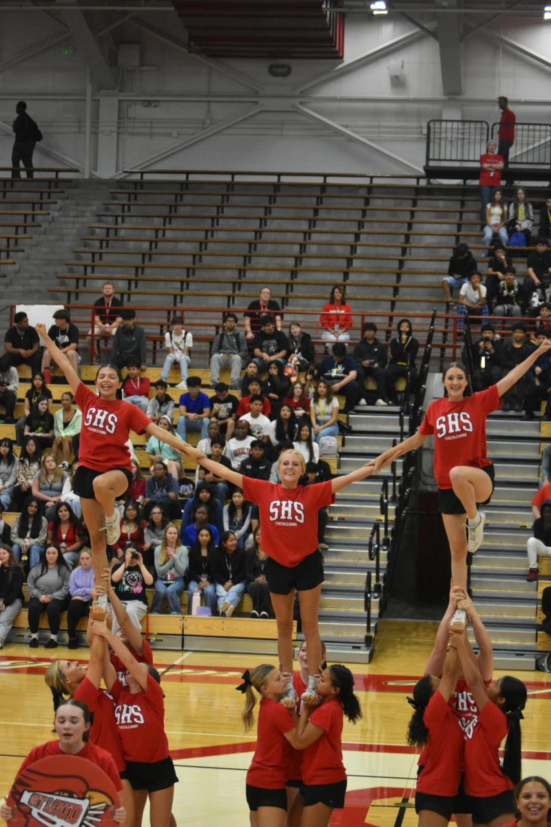 The cheer team performs their routine for the pep session, rallying up the students for the football game later that day. 